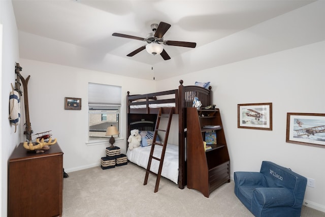 bedroom with a ceiling fan, baseboards, and carpet floors