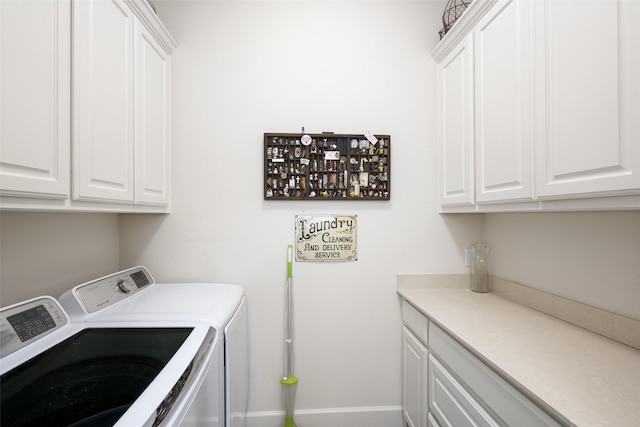 washroom featuring cabinet space, independent washer and dryer, and baseboards