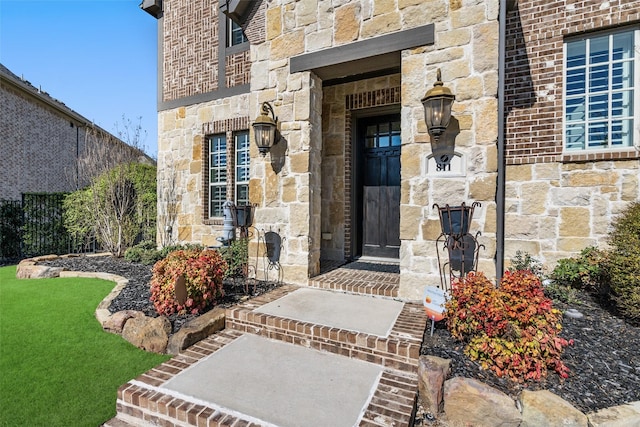 property entrance with brick siding and stone siding