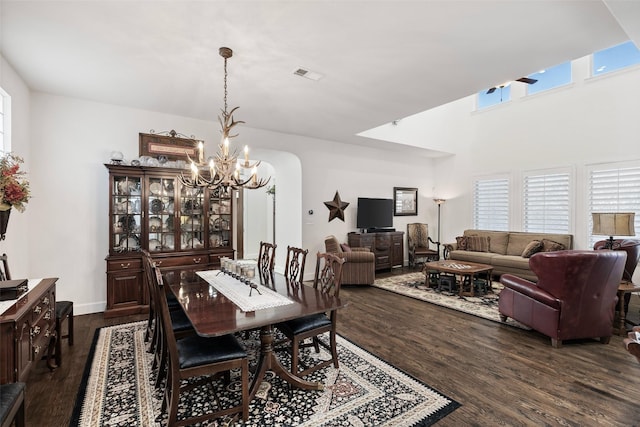 dining space featuring an inviting chandelier, dark wood-style floors, visible vents, and a healthy amount of sunlight