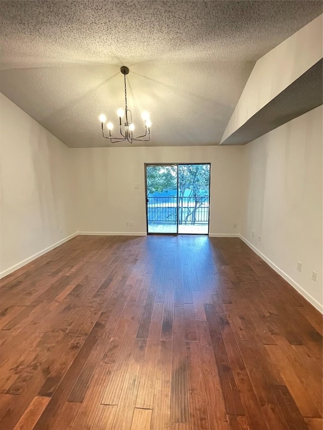 unfurnished room featuring a notable chandelier, baseboards, lofted ceiling, and dark wood-style flooring