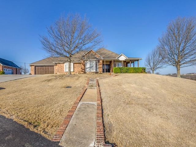 view of front facade with brick siding, an attached garage, and concrete driveway