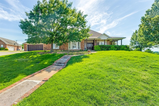 view of front of property with a front yard and brick siding