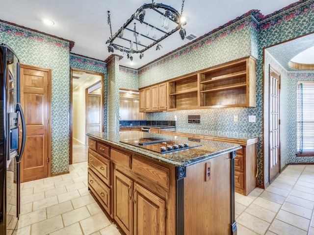 kitchen featuring a kitchen island, wallpapered walls, open shelves, dark stone counters, and black appliances