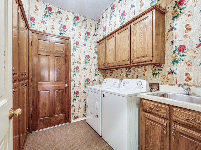 washroom featuring a sink, cabinet space, independent washer and dryer, light carpet, and wallpapered walls