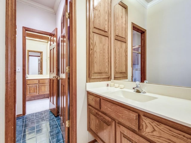 bathroom with tile patterned flooring, vanity, and crown molding