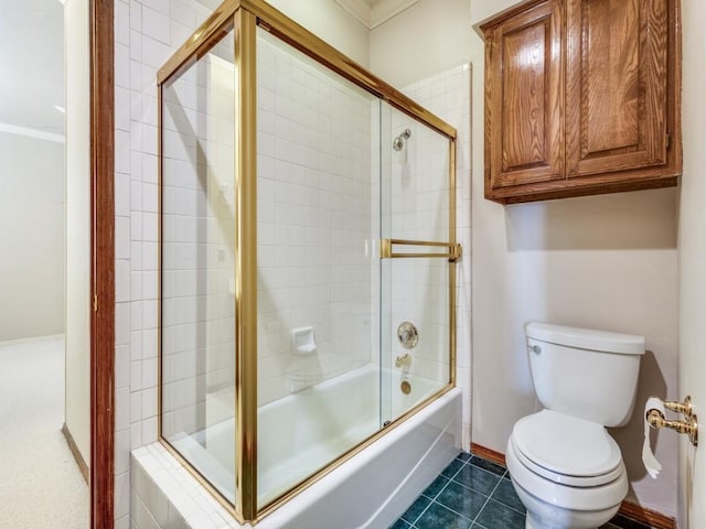 full bathroom featuring toilet, shower / bath combination with glass door, crown molding, baseboards, and tile patterned flooring