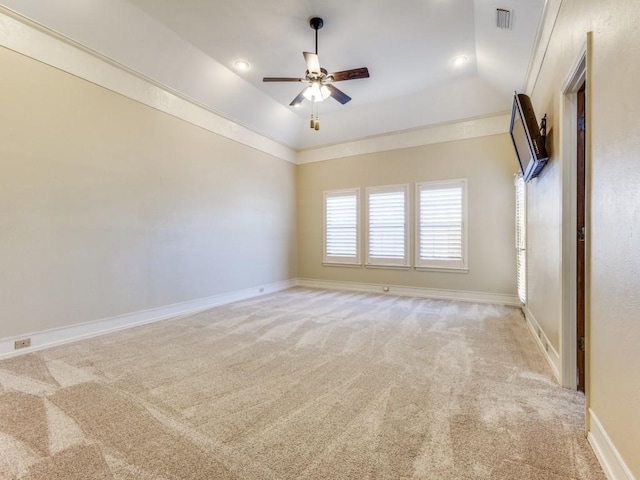 empty room with light colored carpet, visible vents, baseboards, and ceiling fan