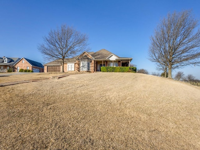 single story home with a front yard and a garage