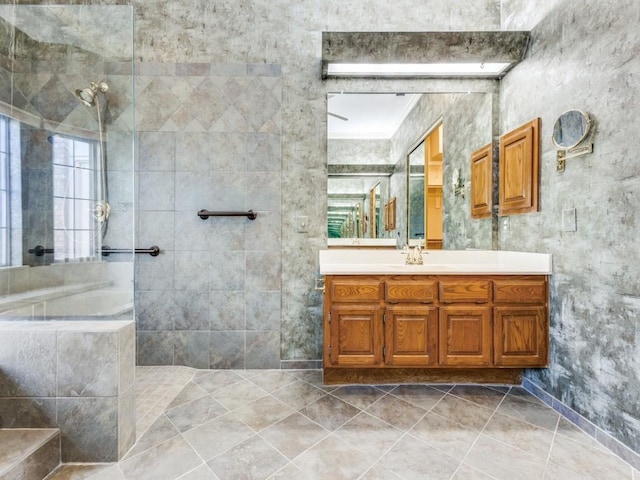 full bath with walk in shower, vanity, and tile patterned flooring
