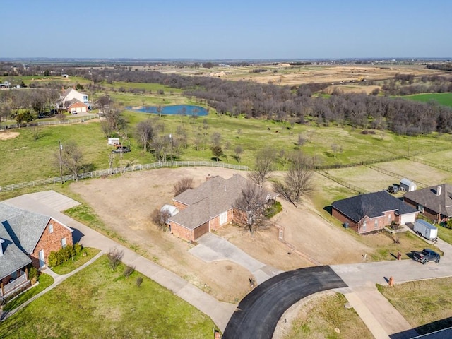 birds eye view of property with a rural view and a water view