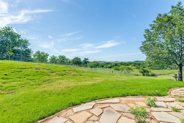 view of yard featuring fence and a rural view