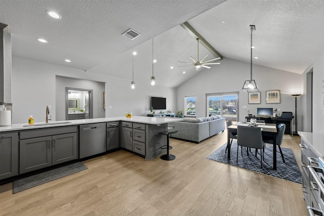 kitchen with light wood-style flooring, gray cabinets, a sink, stainless steel dishwasher, and open floor plan