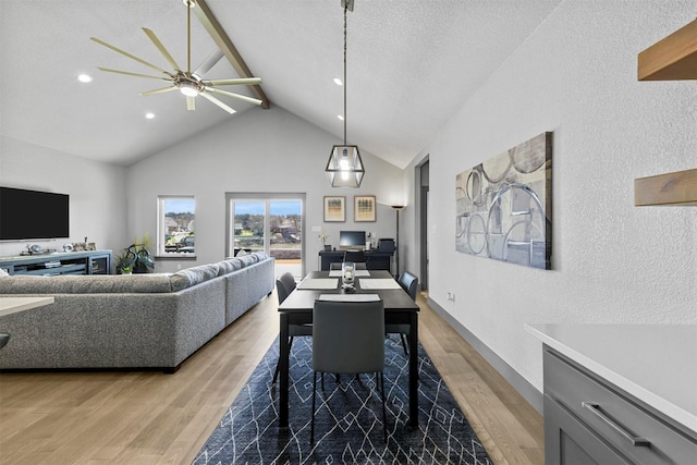 dining room with beamed ceiling, high vaulted ceiling, a textured ceiling, wood finished floors, and a textured wall