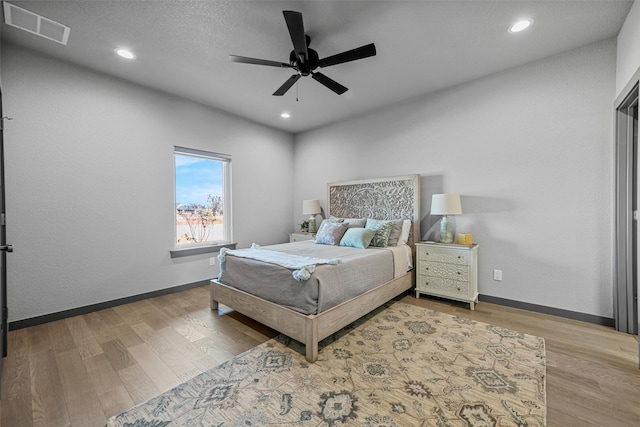 bedroom featuring recessed lighting, visible vents, baseboards, and wood finished floors