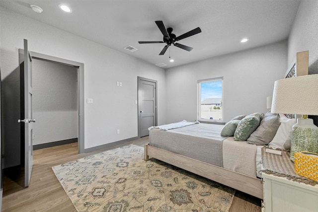 bedroom with visible vents, baseboards, light wood-type flooring, recessed lighting, and a ceiling fan