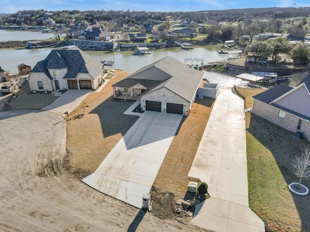 drone / aerial view with a residential view and a water view