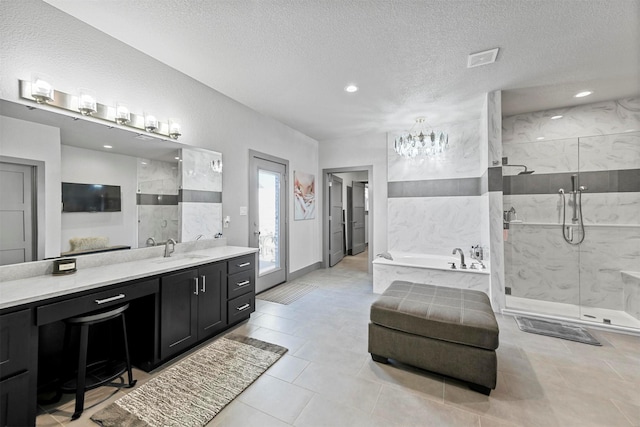 full bath with a marble finish shower, visible vents, vanity, a garden tub, and a textured ceiling