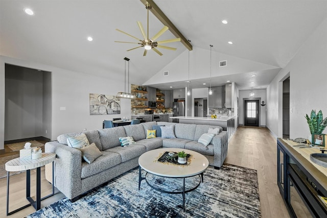 living room with beamed ceiling, high vaulted ceiling, light wood-style flooring, a ceiling fan, and recessed lighting