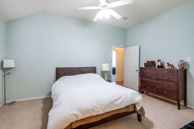 bedroom with light carpet, a ceiling fan, baseboards, and vaulted ceiling