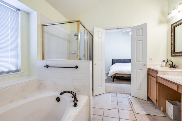 bathroom featuring a stall shower, ensuite bathroom, tile patterned flooring, a bath, and vanity