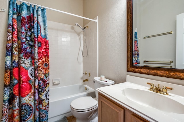 bathroom with toilet, shower / bath combo, vanity, and a textured wall