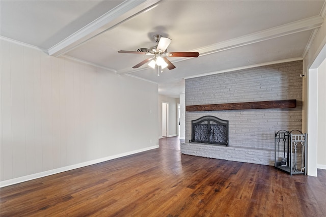 unfurnished living room with ornamental molding, a brick fireplace, brick wall, and wood finished floors