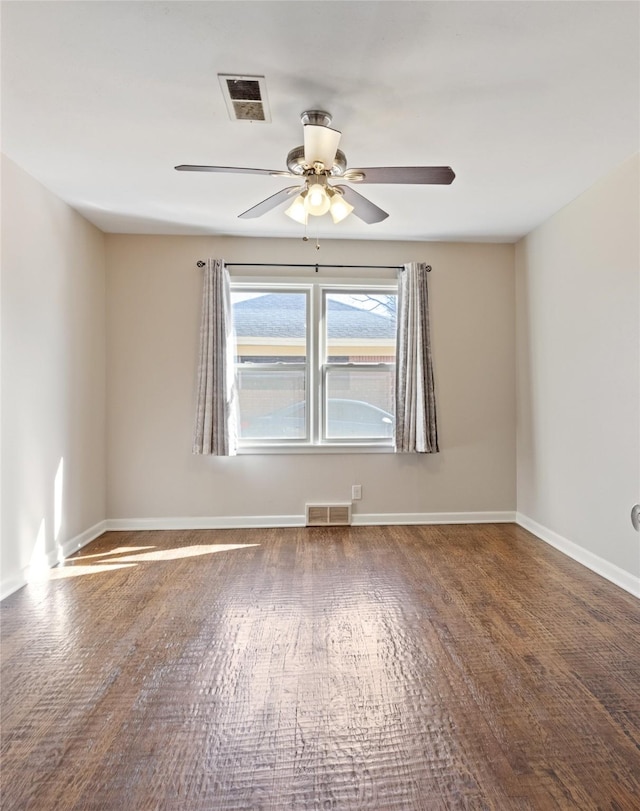 empty room featuring visible vents, baseboards, ceiling fan, and hardwood / wood-style flooring