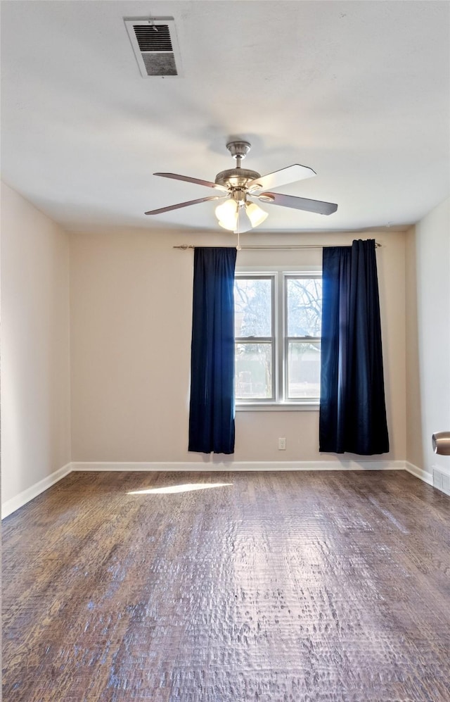 unfurnished room featuring visible vents, a ceiling fan, and baseboards