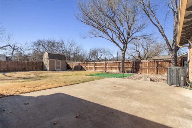 view of yard featuring a storage shed, a patio, an outbuilding, and a fenced backyard