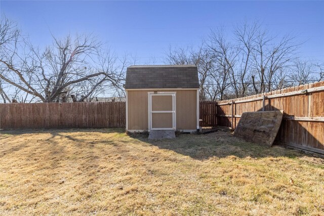 view of shed with a fenced backyard