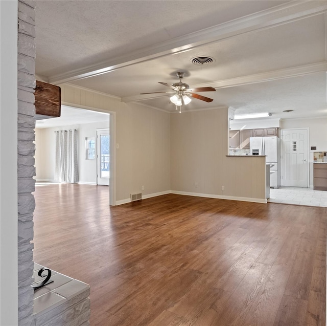 unfurnished living room featuring visible vents, a ceiling fan, light wood-style flooring, and crown molding