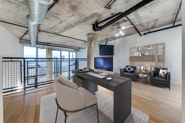 office space with a ceiling fan and wood finished floors