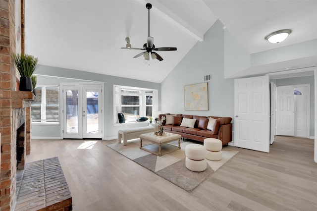 living area featuring visible vents, high vaulted ceiling, wood finished floors, french doors, and ceiling fan