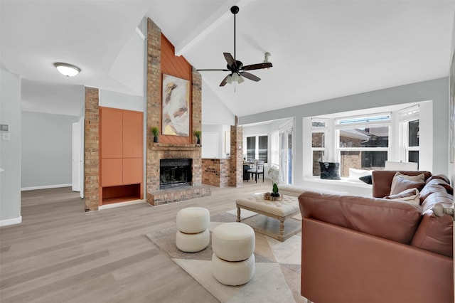 living area with high vaulted ceiling, light wood-style floors, baseboards, a brick fireplace, and ceiling fan