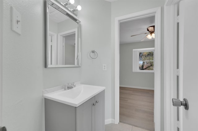 bathroom with vanity, tile patterned floors, baseboards, and ceiling fan