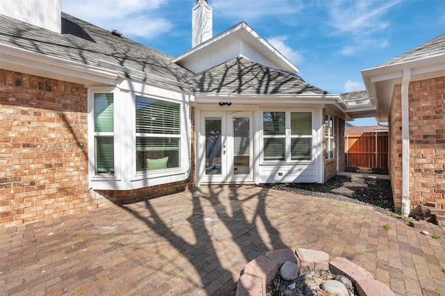 view of patio featuring french doors and fence