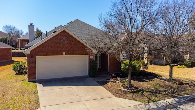 traditional-style house featuring brick siding, driveway, a front lawn, and a garage