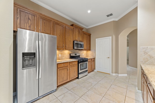 kitchen with visible vents, backsplash, ornamental molding, light tile patterned floors, and appliances with stainless steel finishes