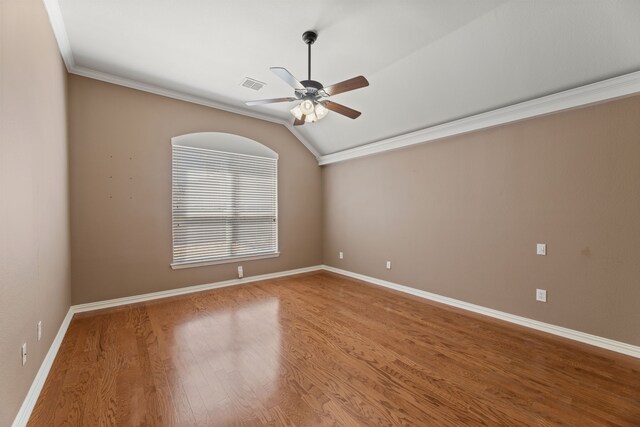 spare room with a ceiling fan, visible vents, wood finished floors, baseboards, and lofted ceiling