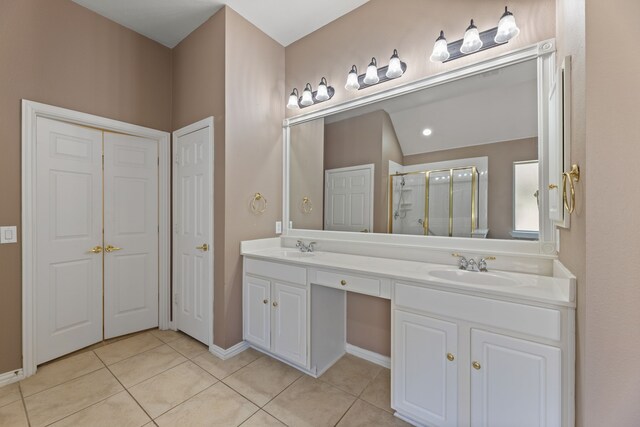 full bathroom featuring a sink, a stall shower, and tile patterned flooring