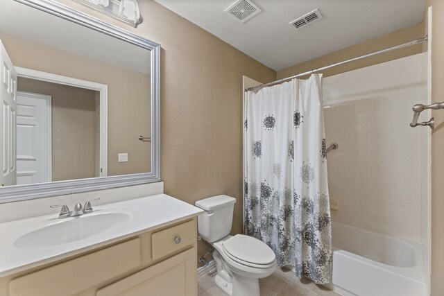 bathroom featuring tile patterned floors, visible vents, toilet, and vanity