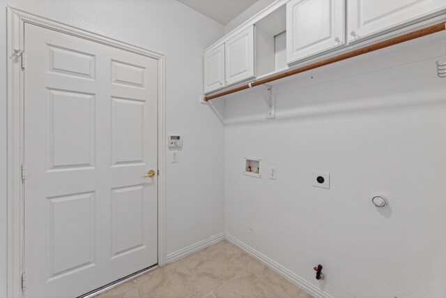 washroom with baseboards, gas dryer hookup, washer hookup, cabinet space, and hookup for an electric dryer