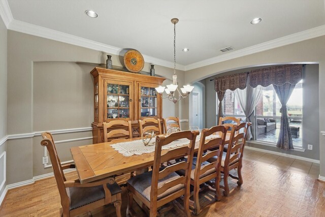 dining space with visible vents, arched walkways, and ornamental molding