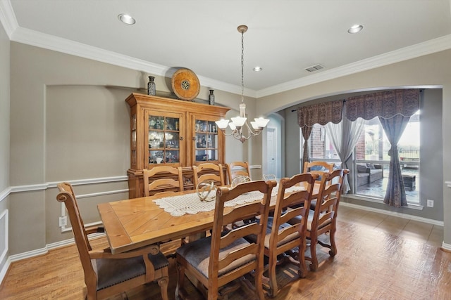 1231 Mcclintock Dr, Shady Shores, TX 76208 - dining area featuring a chandelier, arched walkways, ornamental molding, light wood-style flooring, and recessed lighting