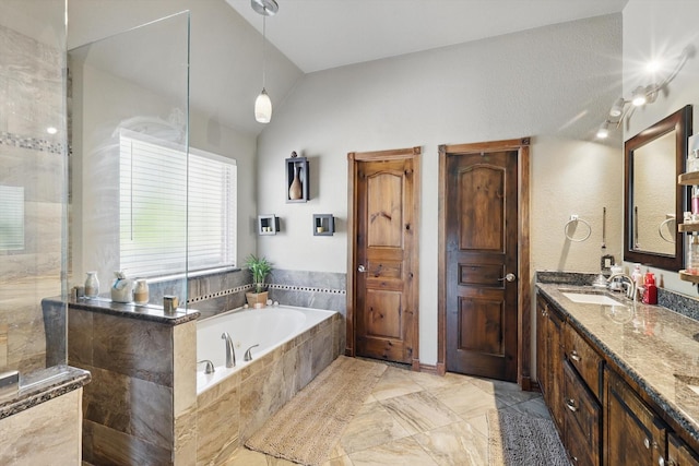 full bathroom with vanity, vaulted ceiling, a bath, and a walk in shower