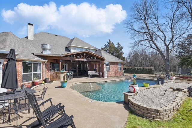 outdoor pool featuring outdoor dry bar, a patio, and a trampoline