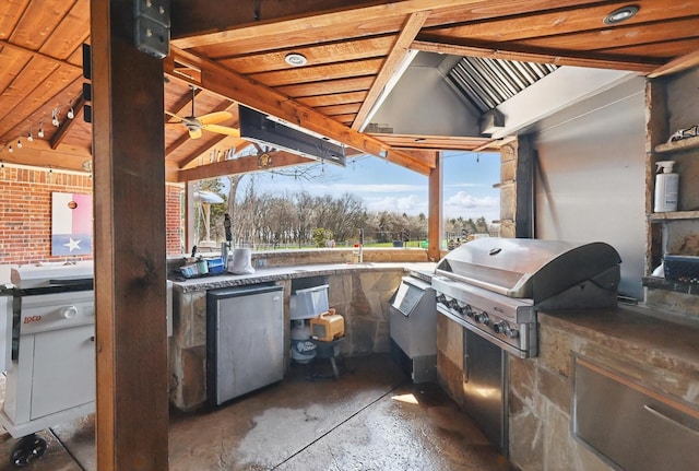 view of patio featuring area for grilling and a grill