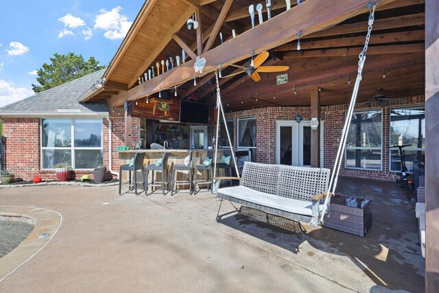 view of patio / terrace featuring ceiling fan and outdoor dry bar