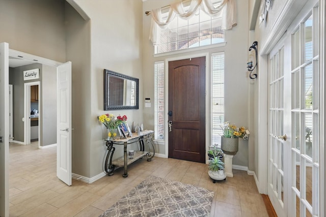 1231 Mcclintock Dr, Shady Shores, TX 76208 - foyer with a high ceiling, light wood-type flooring, baseboards, and arched walkways